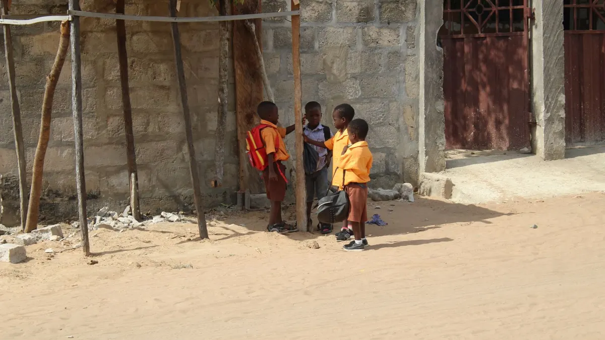 Group of schoolchildren in uniforms gathered outdoors