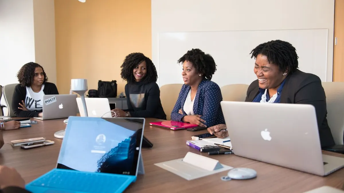 Kenyan colleagues reviewing job application documents together in a meeting room