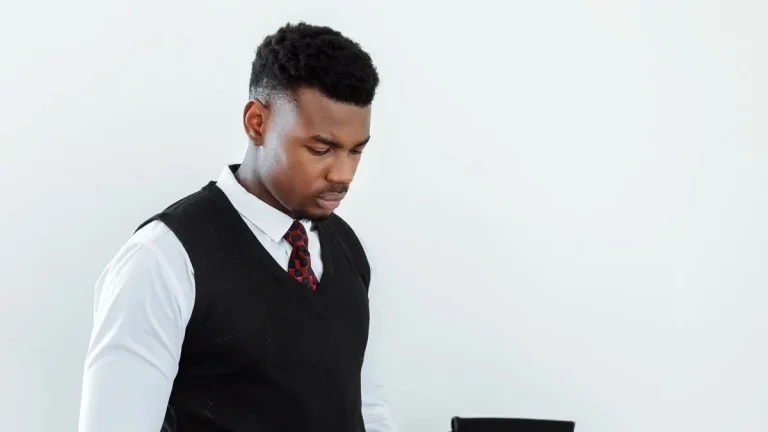 Kenyan job seeker carefully checking a job advert in his notebook before applying