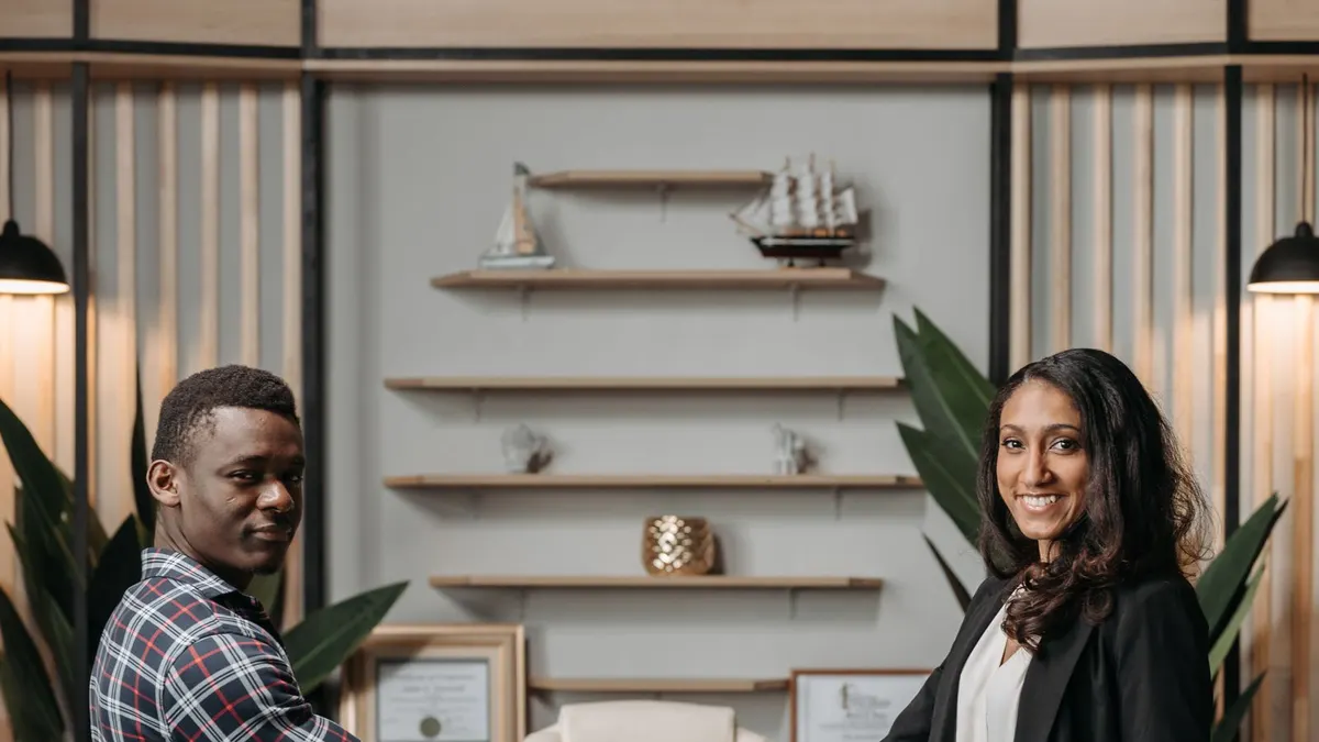Young man shaking hands with his new manager in a modern office