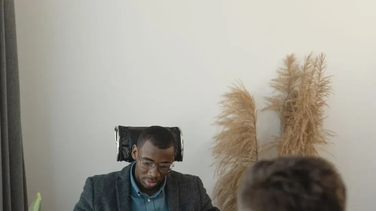 Kenyan job candidate discussing a salary offer with an employer across a desk